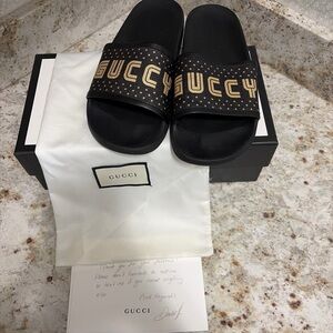 Gucci Black Slides with Gold Logo Detailing